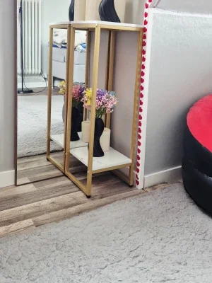 Modern side table with gold frame and marble top