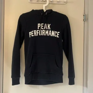 Mörkblå hoodie Peak Performance XS
