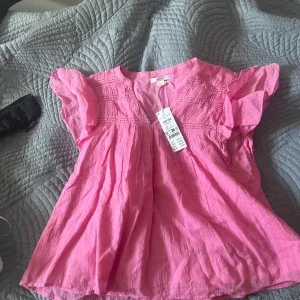 Rosa blus med volangärmar från gina