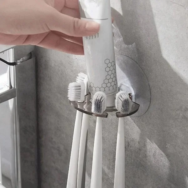 Wall-mounted toothbrush holder with suction cups and toothpaste storage, suitable for the bathroom.