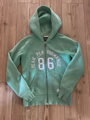 Grön hoodie Peak Performance 86