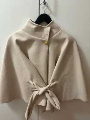 Beige poncho med knyt och guldknapp