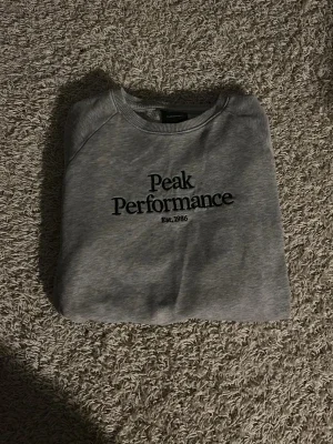Grå tröja Peak Performance