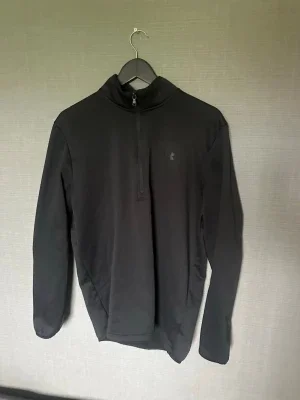 Svart halvzip tröja från Under Armour