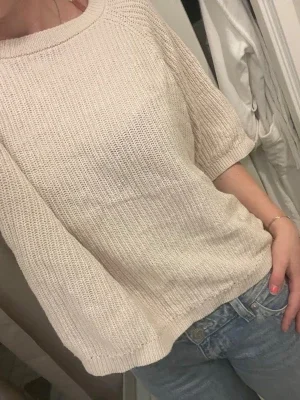Beige stickad tröja med trekvartsärm