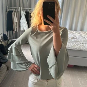 Grön blus med volangärmar