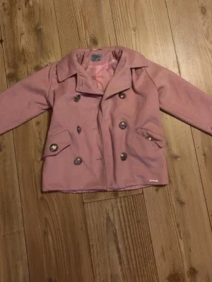Rosa kappa från Kids by Voga