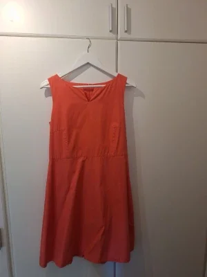 Korall eller orange ärmlös klänning