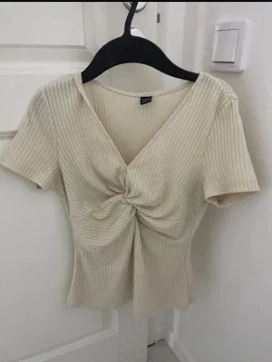 Ribbad beige topp med twist framtill